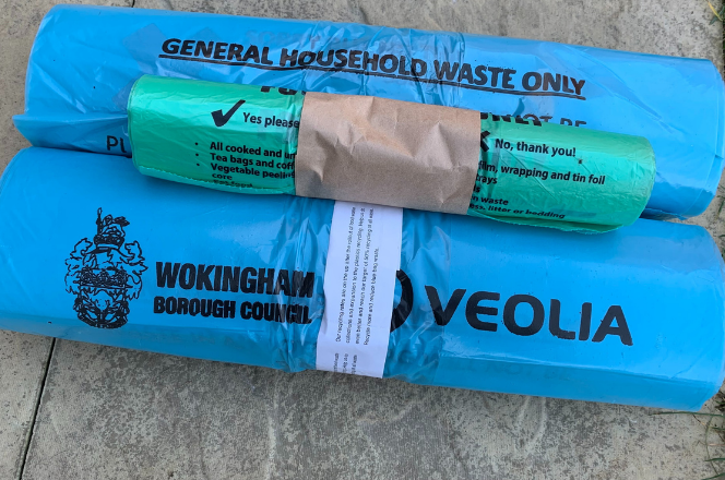 two blue waste bag rolls and one food waste caddy liner roll