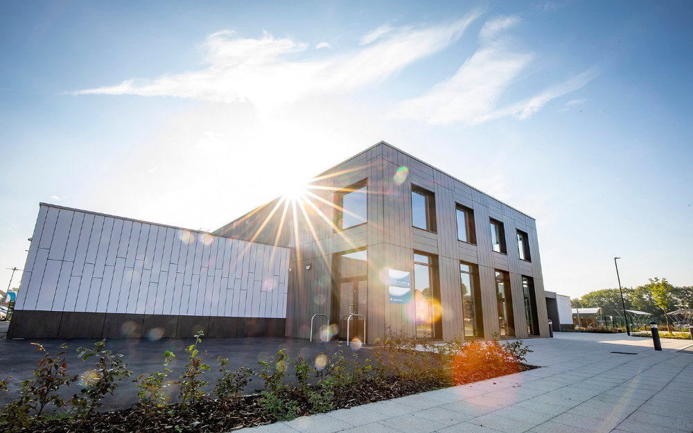 Farley Hill primary school with the sun breaking over the edge of the roof 