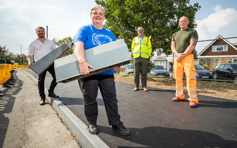 Cllr Pauline Jorgensen and Cllr Gregor Murray helping to install new plastic kerbs 