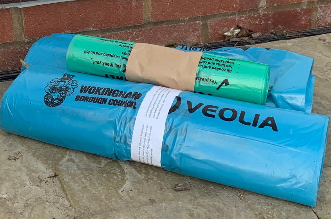 image of two blue bag rolls and one green food caddy liner roll