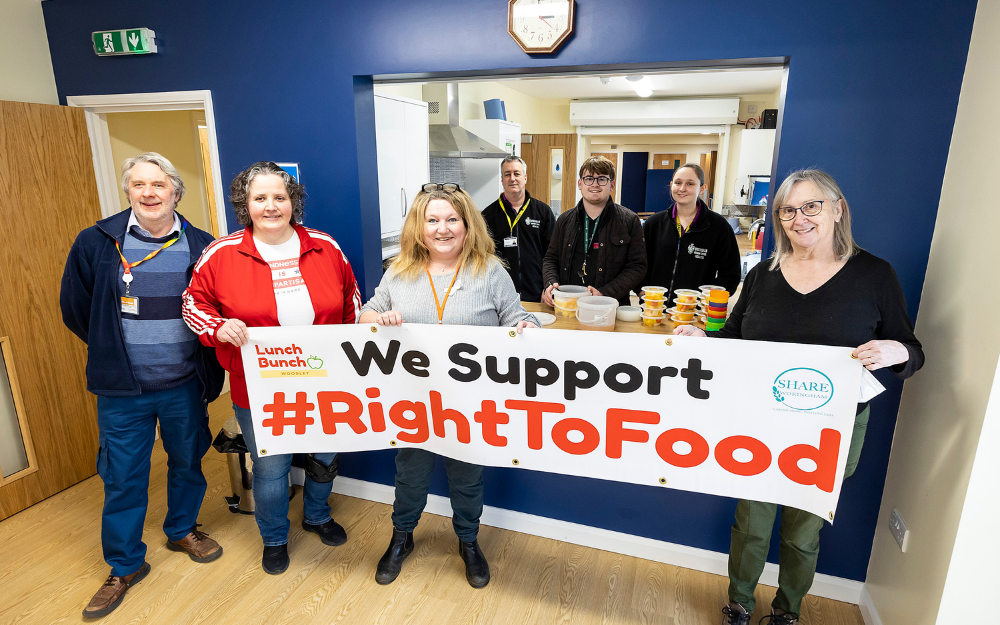 volunteers from charities and staff from the council smile at the camera during the opening of the new community hub in woodley