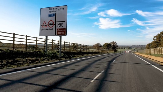 Photograph of the Arborfield Cross Relief Road / Observer Way from a driver's eye perspective with no traffic ahead, on a sunny day