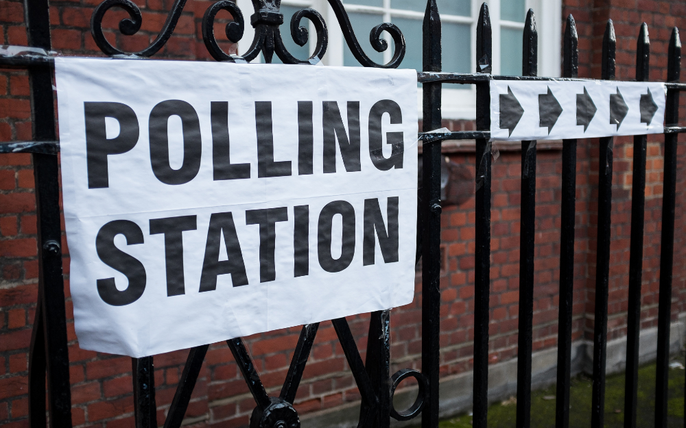 A railing with a banner reading 'polling station' on display