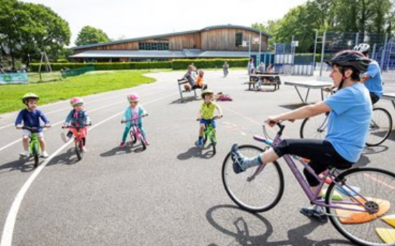 MyJourney cycling teacher showing a group of young children on bikes how to improve their pedalling skills  