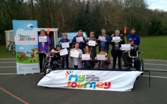 Group photo of the Woky Wheels 4 All attendees holding certificates after taking part in a training session 