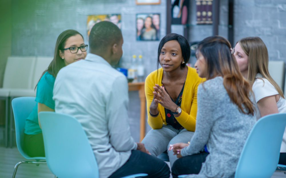 A group sat in supportive discussion