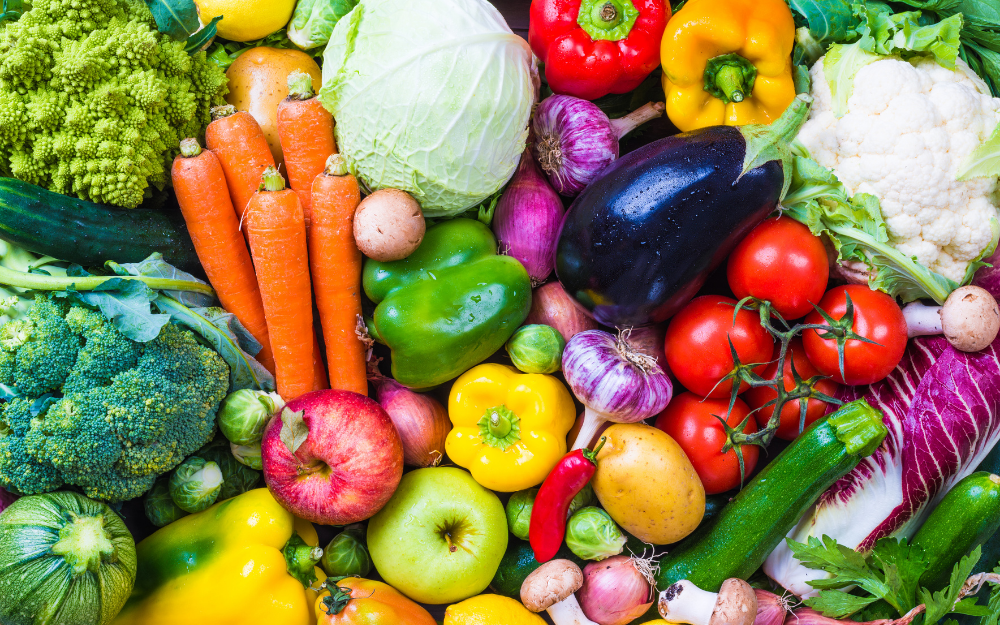 An array of colourful fruit and vegetables spread out over a table