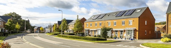 wide shot looking at new housing on Montague Park from across an empty street on a summer's day