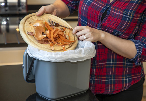 Putting food waste in a caddy