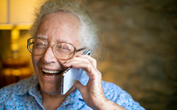 Older person on the phone smiling