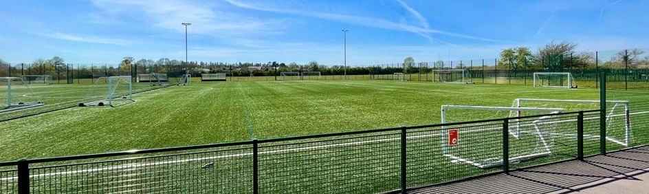 wide shot of the artificial playing field at Ryeish Green Sports Hub on a sunny day