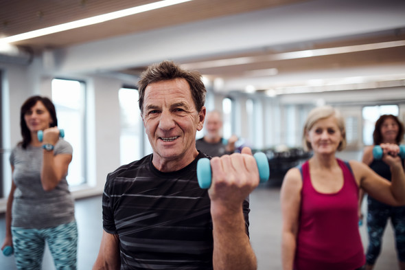 man and women attending weight training exercise class