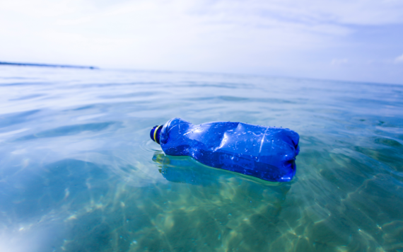 A blue plastic bottle floating in the sea