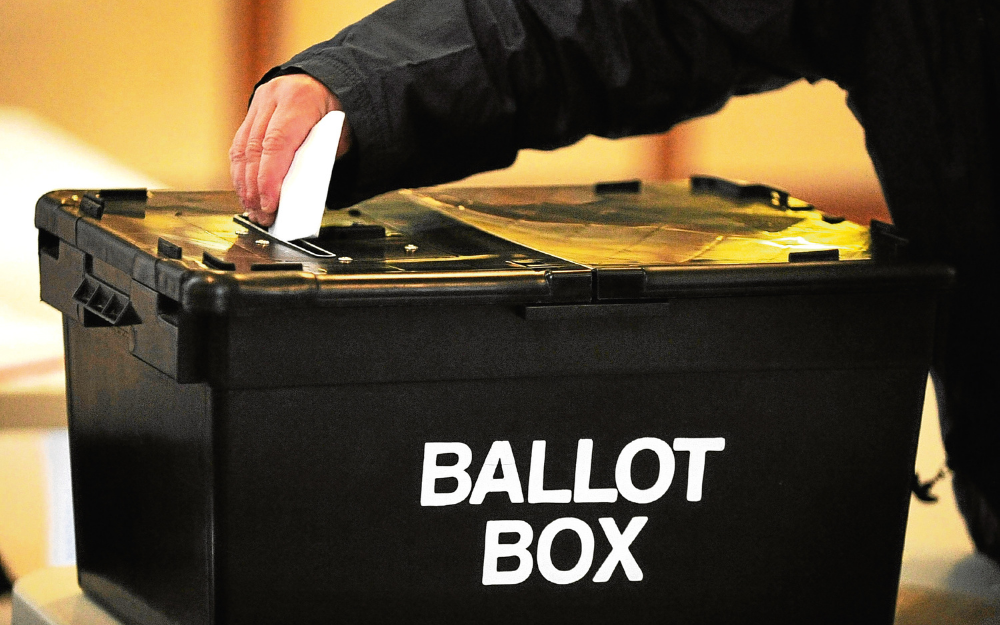 A ballot being placed into a ballot box