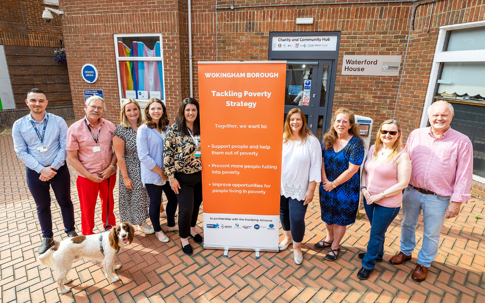 The Wokingham Borough Hardship Alliance pose next to their banner at the voluntary and community hub in Wokingham