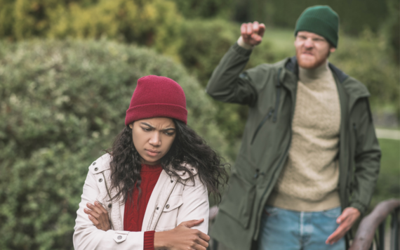 Man shouting abuse at a woman walking in a park 