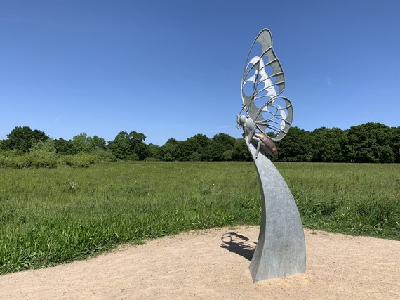 photograph of the metal butterfly sculpture on Buckhurst Meadow on a beautiful, sunny day