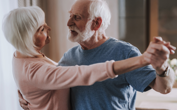 An older couple dancing together