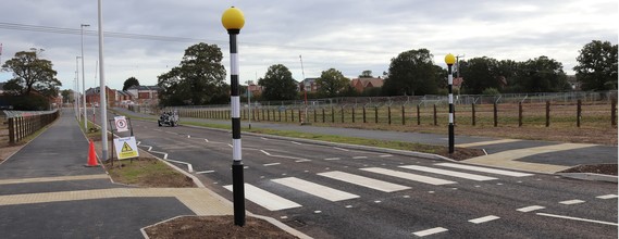 a zebra crossing with orange beacons and wide foot and cycle path either side, part of North Wokingham Distributor Road at Ashridge Farm