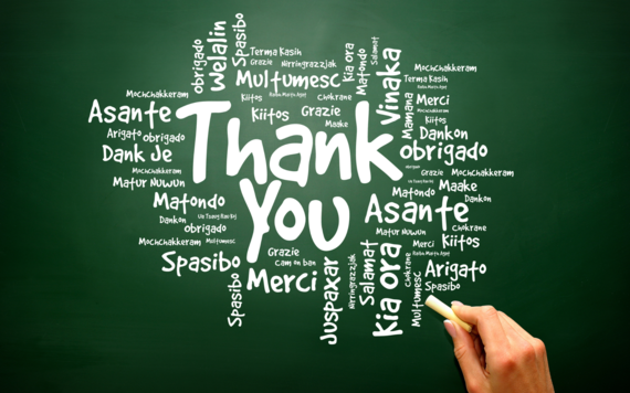 The words thank you in English and other different languages on a green background