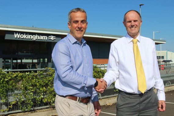 Cllr Charles Margetts and Cllr Paul Fishwick shake hands outside Wokingham station