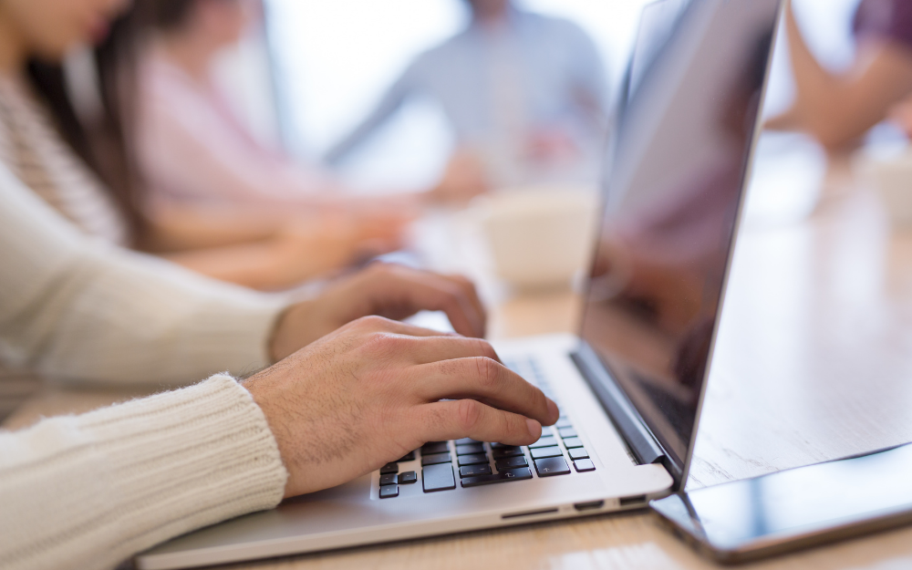 Hands using a laptop computer