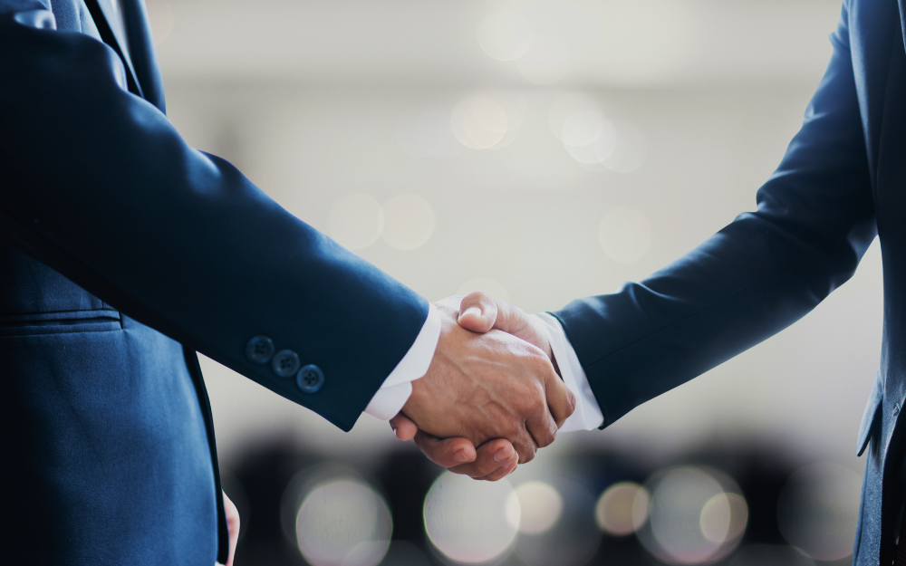 Two men in suits shaking hands