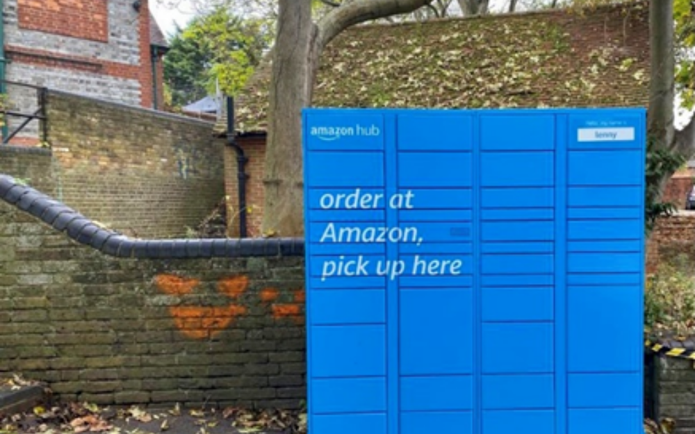 A blue parcel locker in a car park