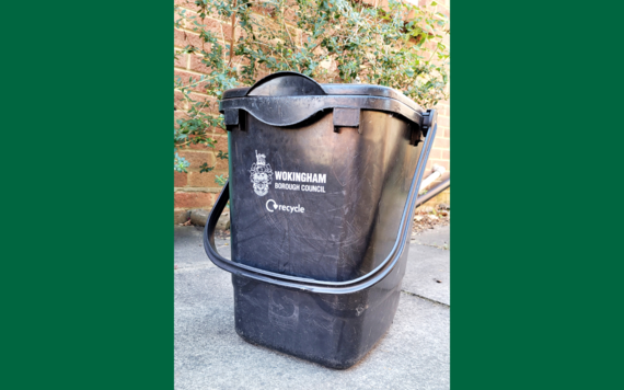 A photo of Wokingham borough's black food waste bin, with its long arm pulled to its front
