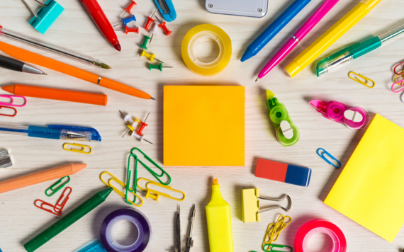 An image of different stationery such as post-it notes, pens, highlighters, clips, tape and push pins