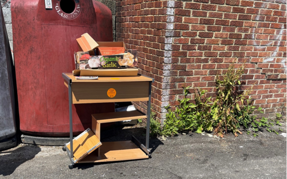 The fly-tipped desk and boxes left outside Premier Convenience Store in Woodley