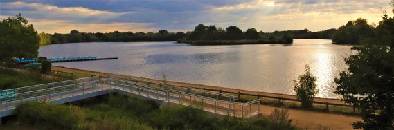 View over the lake at Dinton Pastures on a cloudy sunset from the deck of the Dinton Activity Centre