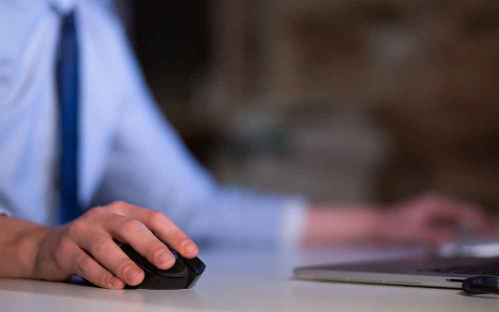 A man using a mouse on a computer