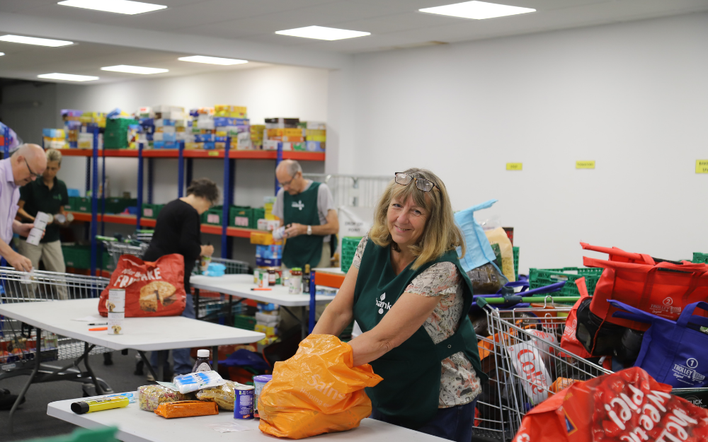 Cllr Caroline Smith fills a bag at Wokingham Food Bank