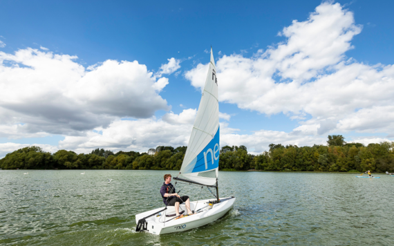 A teenager sailing on the lake in Dinton Pastures Country Park