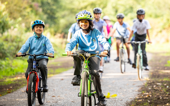 Some school children cycling on the new greenway crosses Woosehill Meadows