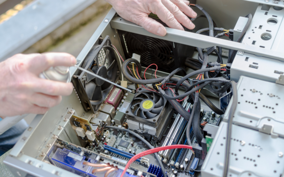 A top of the inside of a computer being fixed 