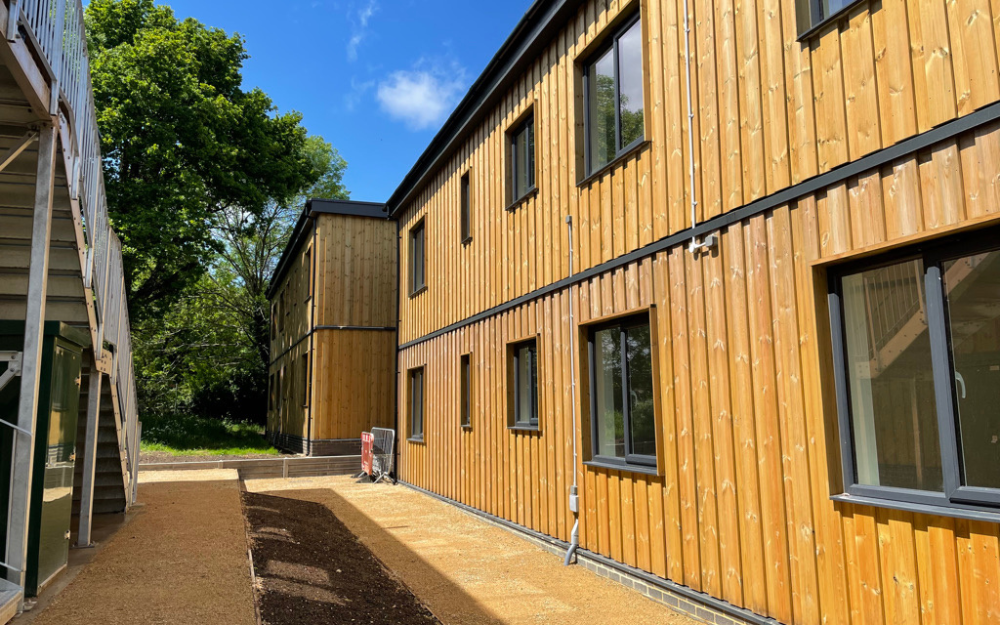 A block of new stackable housing in the sunshine at Grovelands in Winnersh