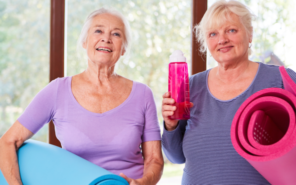 Two ladies with yoga mats