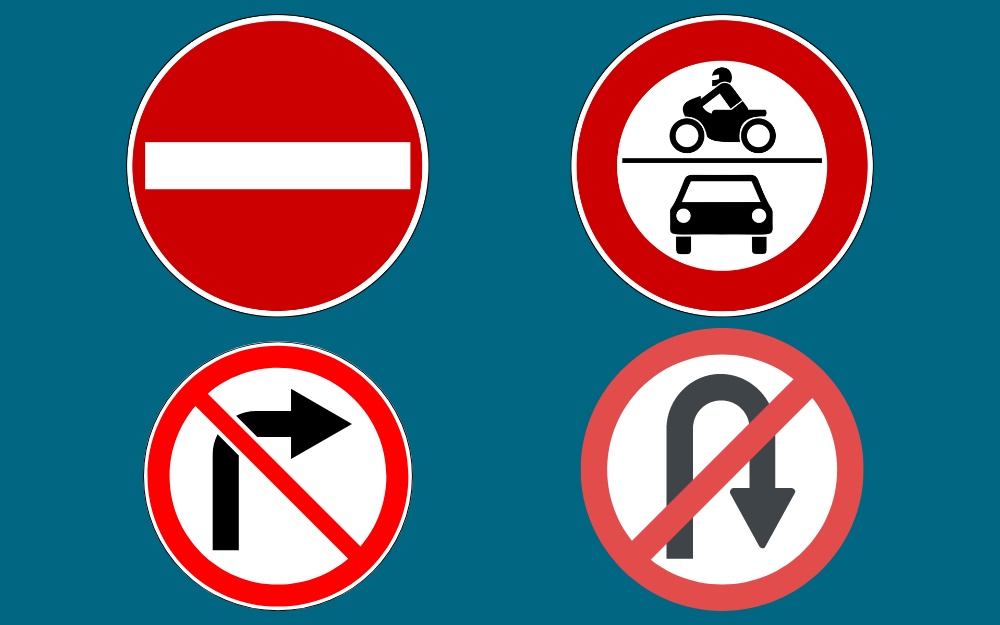 Four road signs, including no entry, no left turn, no u-turns and bus lane