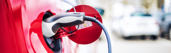 close up of  a charger plugged into an electric vehicle