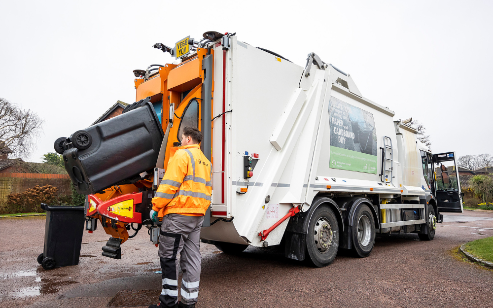 A waste crew loads recycling and rubbish into a waste lorry