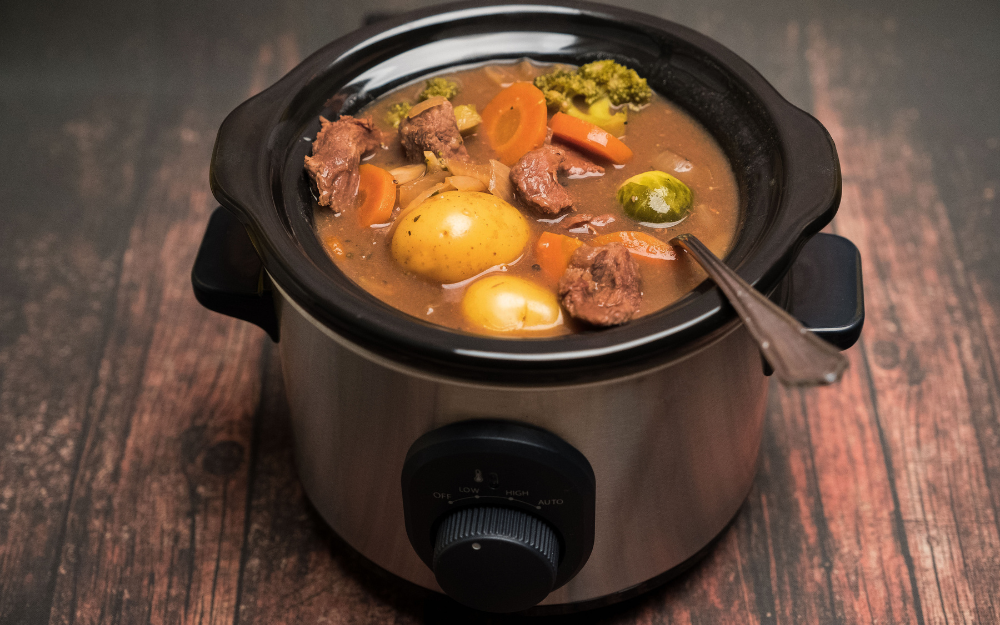 A slow cooker with food inside it