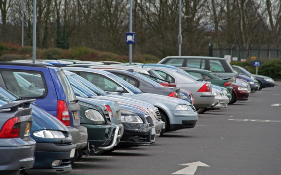 A row of cars parked in a car park