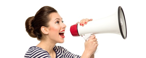 a woman shouting happily through a megaphone