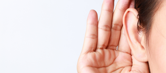 close up of a hand to an ear, indicating listening