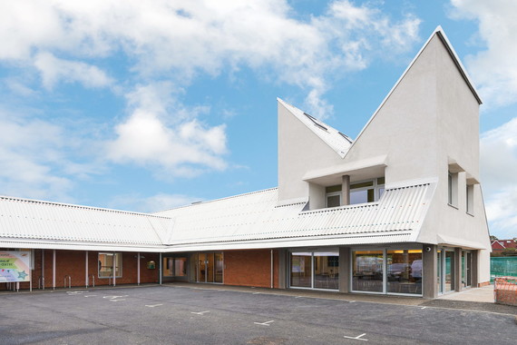 photo of Shinfield Community Centre with a sunny blue sky behind