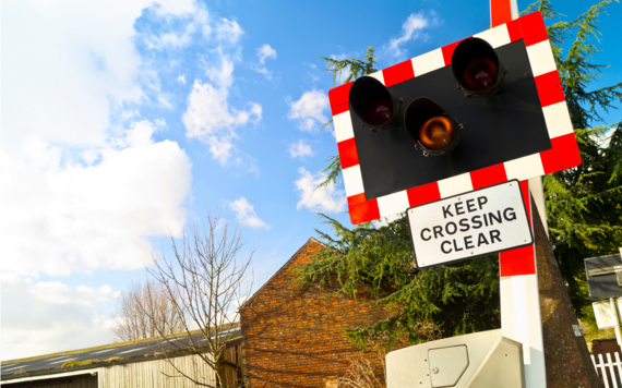 A level crossing light and sign