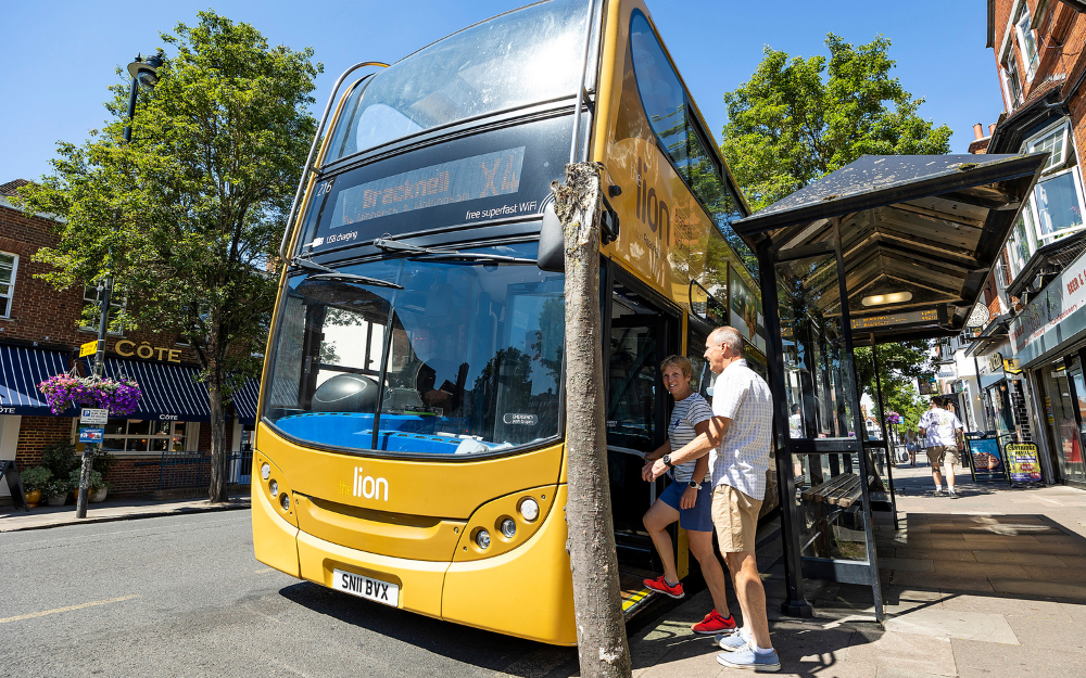 A man and woman get onto an X4 bus towards Reading in Broad Street, Wokingham