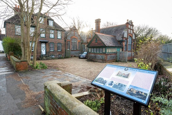 Photo of the Polehampton Trust building with an information plaque outside, which will house the new Twyford Library